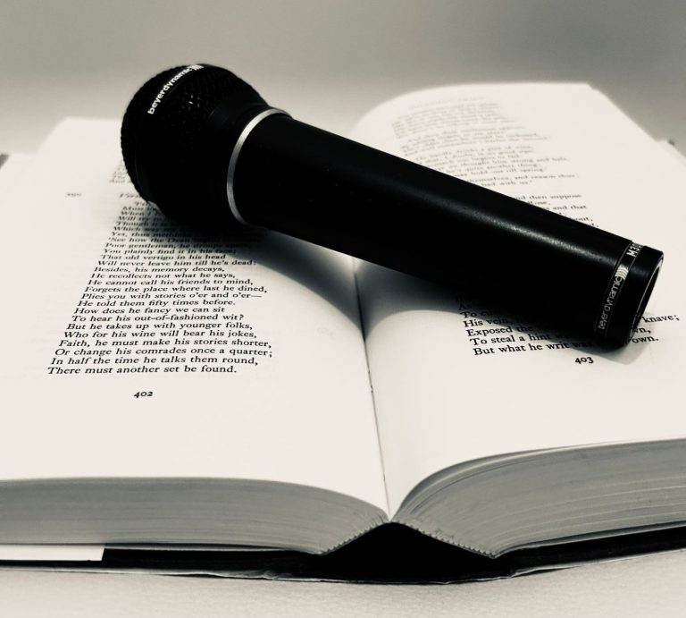 Open poetry book with microphone on top