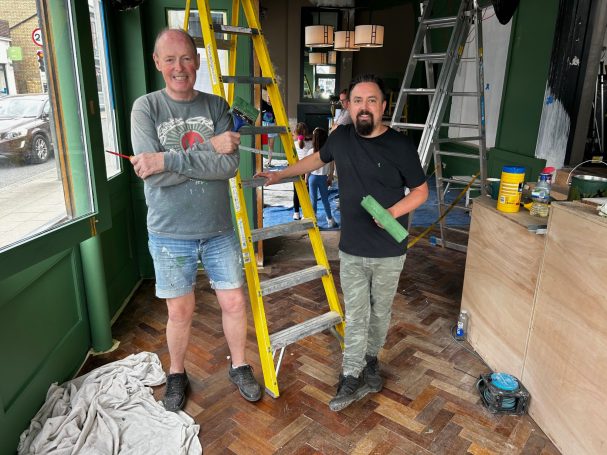 Two men having a rest from painting